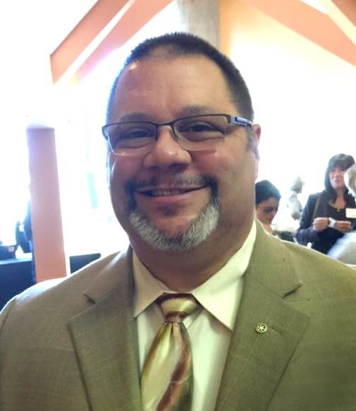 Pete Constant at an event smiling wearing suit tie eyeglasses and sporting a goatee (color photo)